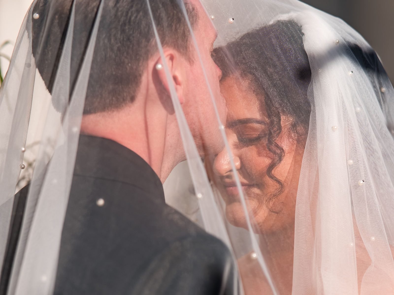 A close kiss under the bride's veil